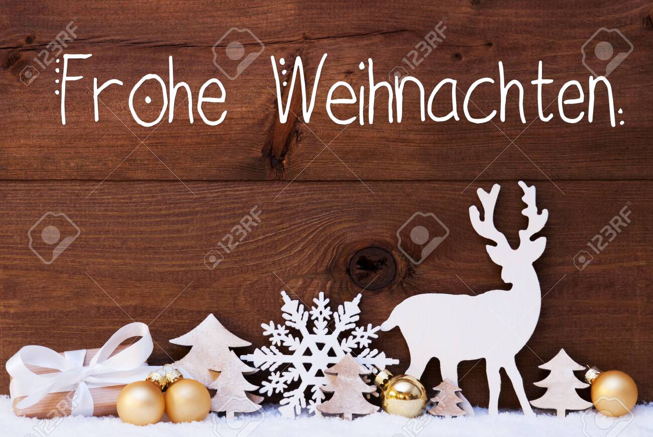 German Calligraphy Frohe Weihnachten Means Merry Christmas Golden Christmas Decoration Like Tree Gift Ball And Reindeer Wooden Background With Snow Stock Photo Picture And Royalty Free Image Image 133616587