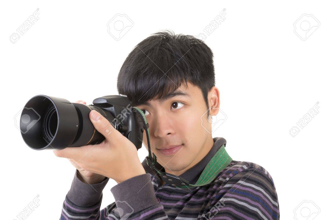 Stock Photo - Young amateur photographer of Asian hold a camera, closeup portrait on white background.