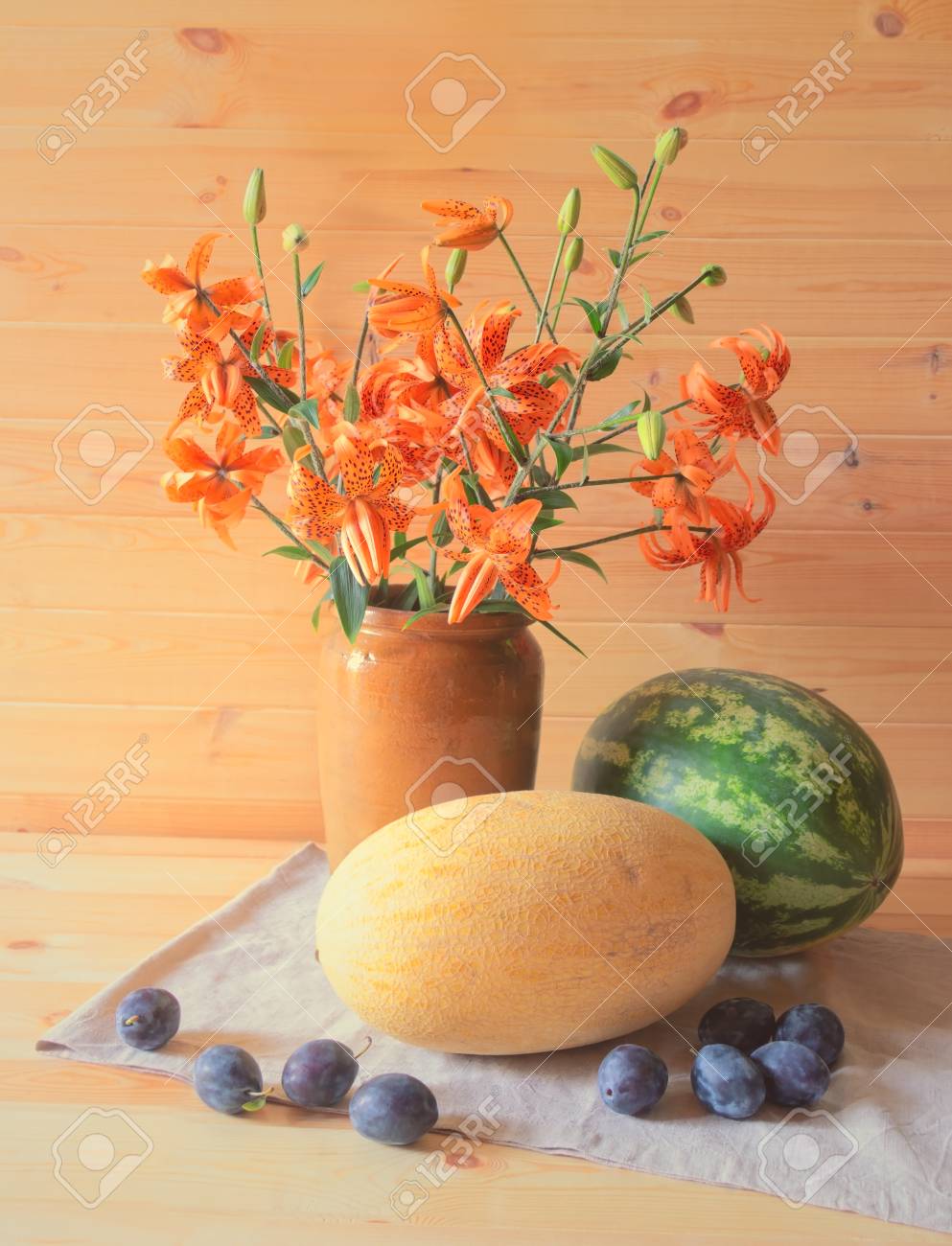 Bouquet Of Orange Lilies In Clay Vase Watermelon Melon And
