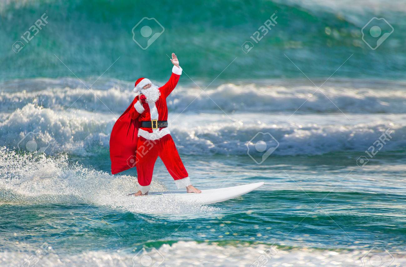 66275349-santa-claus-windsurfer-with-large-holiday-gifts-sack-go-surfing-with-surfboard-at-ocean-waves-splash.jpg