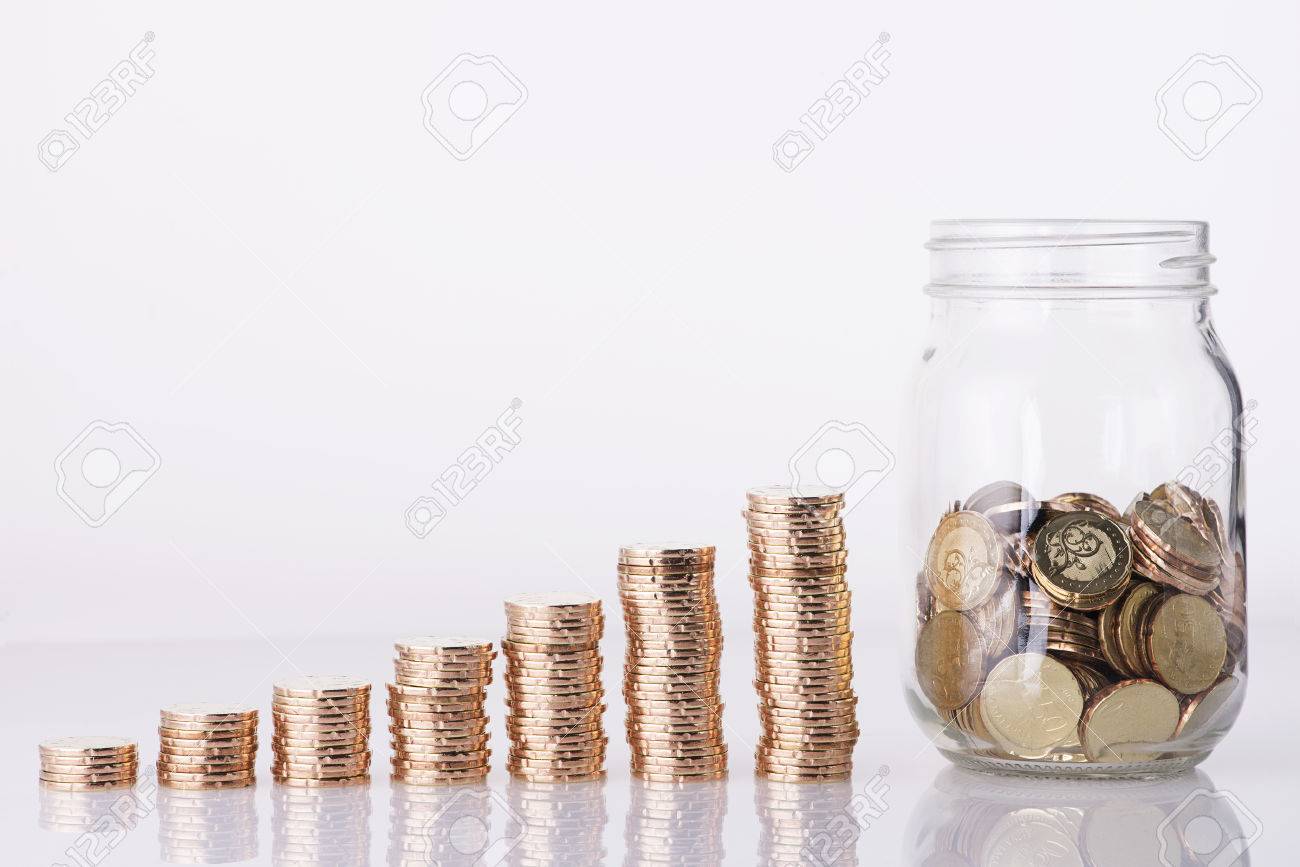 Image of Golden coins stacked and penny jar over white background - 52123020 Image of Golden coins stacked and penny jar over white background - 52123020