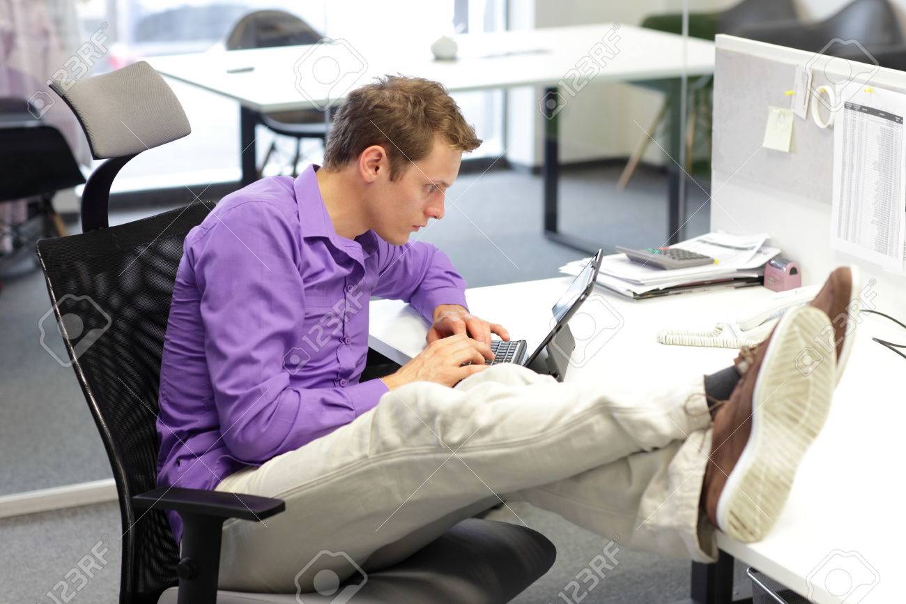 Young businessman caucasian in his office working with tablet - bad sitting posture - 25313505 Young businessman caucasian in his office working with tablet - bad sitting posture - 25313505