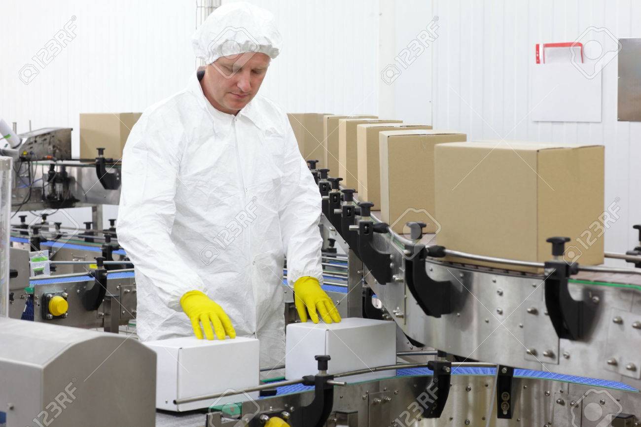 caucasian worker in apron, cap at production line in factory - 29391875 caucasian worker in apron, cap at production line in factory - 29391875