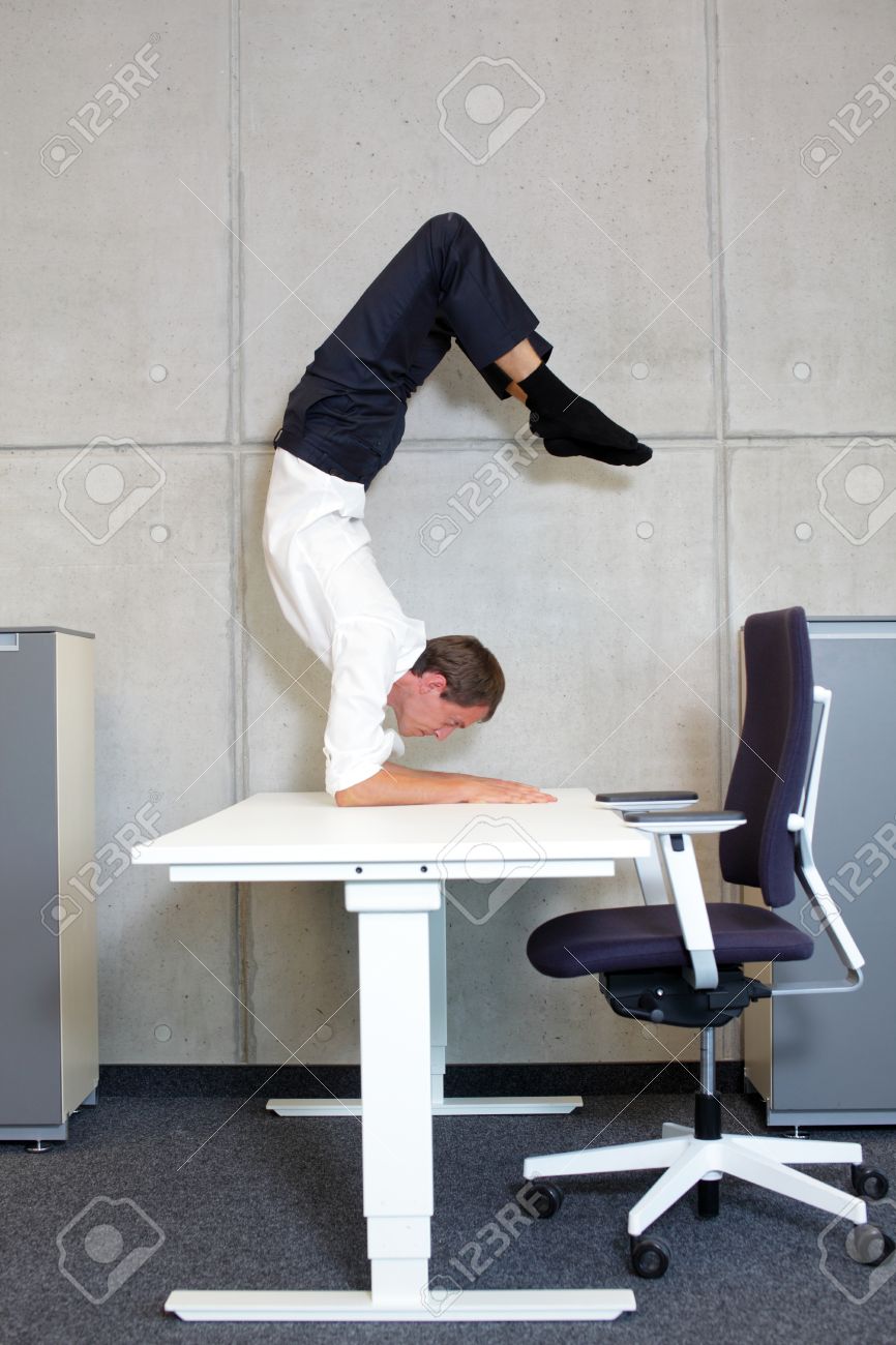 fit,flexible business man in scorpion asana on desk in his office - 38259009 fit,flexible business man in scorpion asana on desk in his office - 38259009