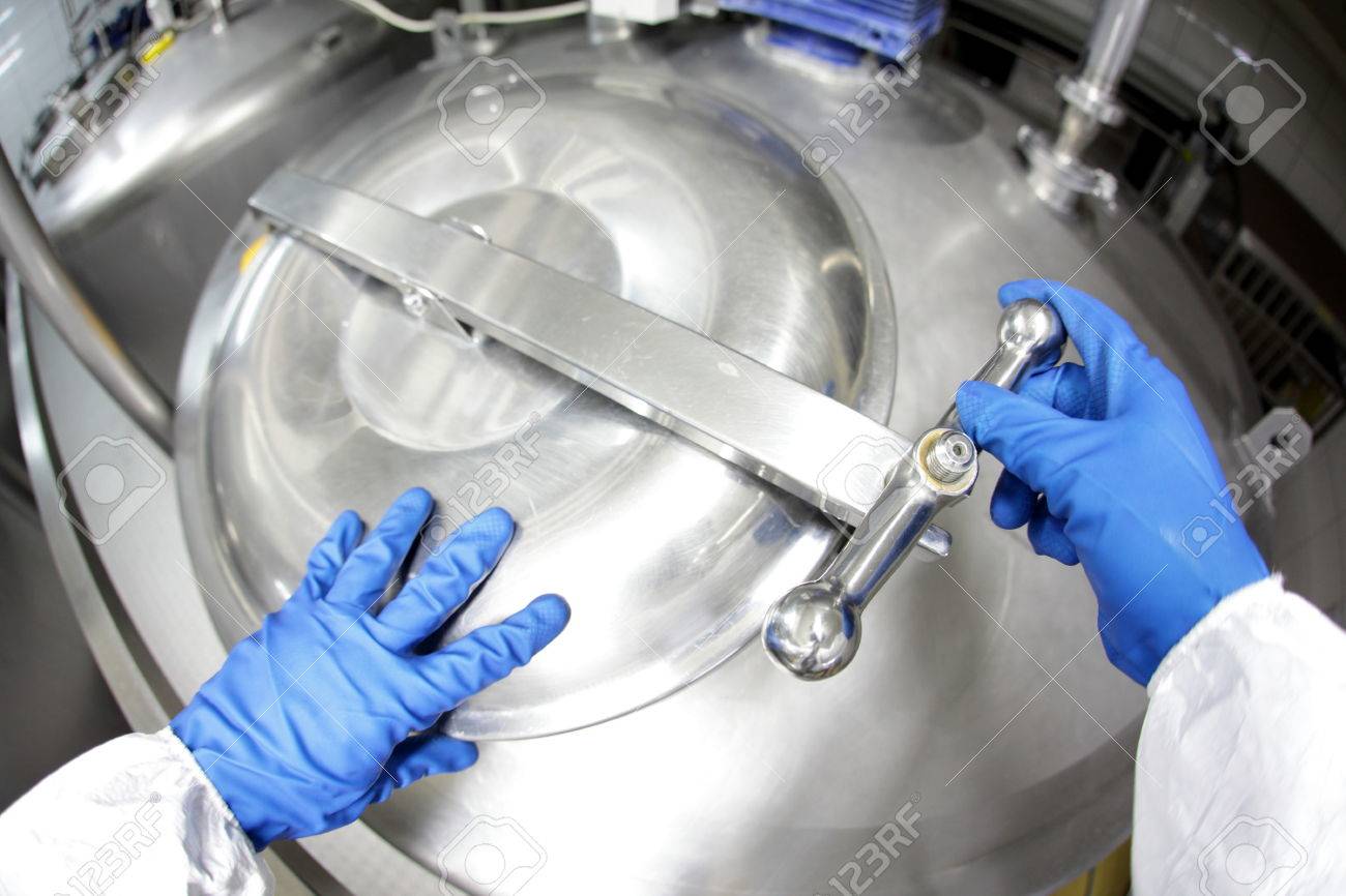 hands in blue gloves opening industrial process tank - 47033799 hands in blue gloves opening industrial process tank - 47033799