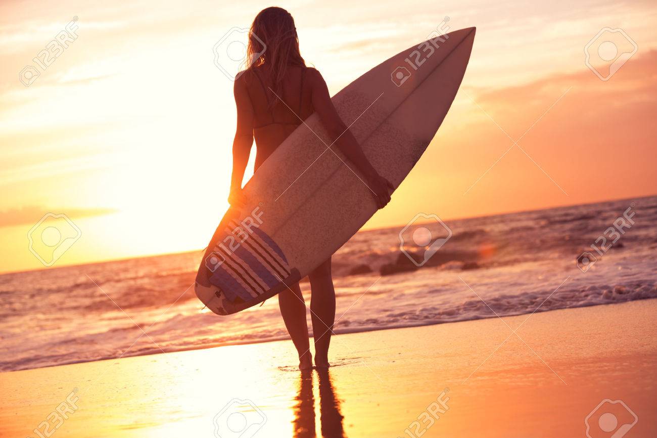 夕暮れ時のビーチの美しいサーファーガールのシルエット の写真素材 画像素材 Image