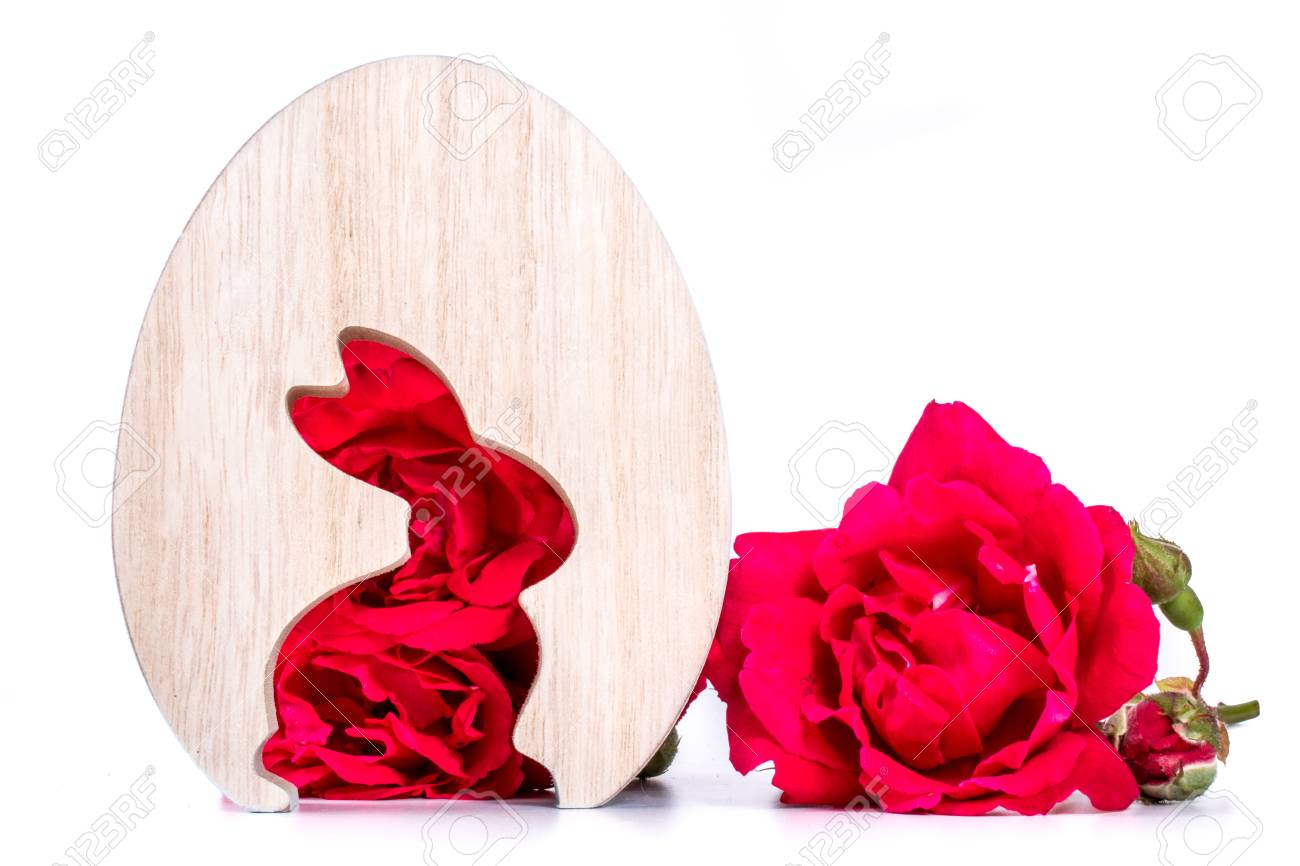 close up of wooden easter egg with rabbit shape of rose flowers