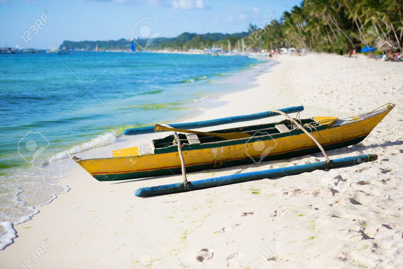 old wooden bangka boat on white sand beach at boracay philippines