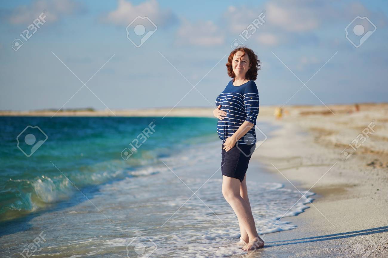 Happy Pregnant Woman On The Beach Near The Sea Vacation During Stock Photo Picture And Royalty Free Image Image 99610339