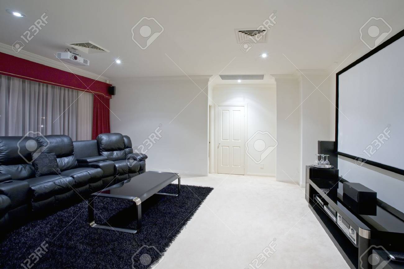 home theater room with black leather recliner chairs stock photo