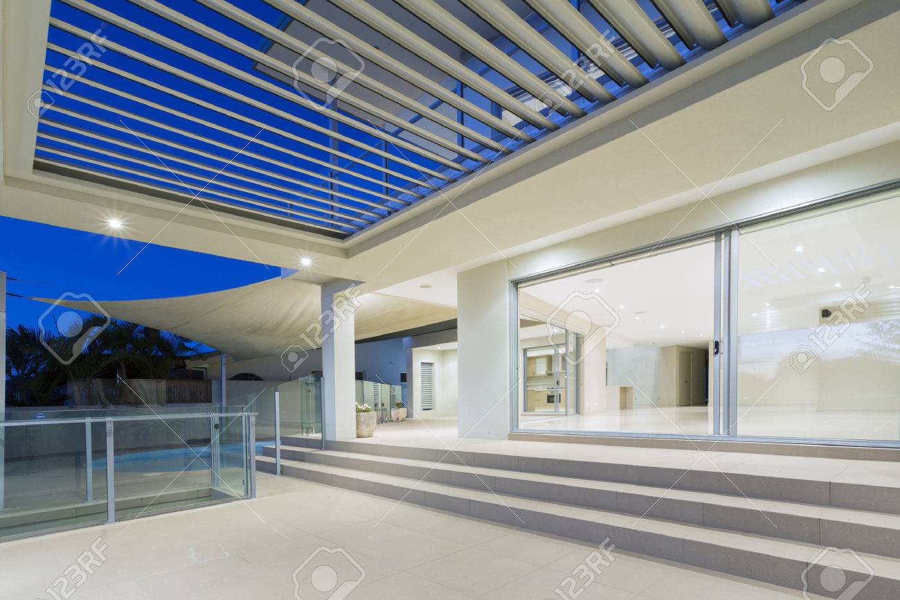 Stock photo white modern luxurious mansion exterior with deck and swimming pool on the gold coast queensland australia
