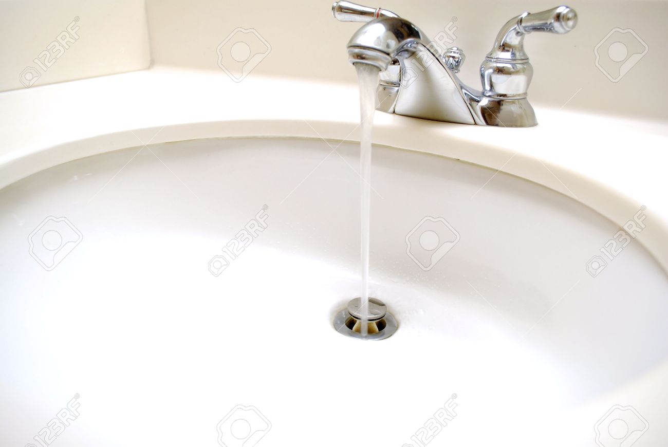 Water Coming Out Of Spout In Bathroom Sink And Going Down The Stock Photo Water Coming Out Of Spout In Bathroom Sink And Going Down The Stock Photo