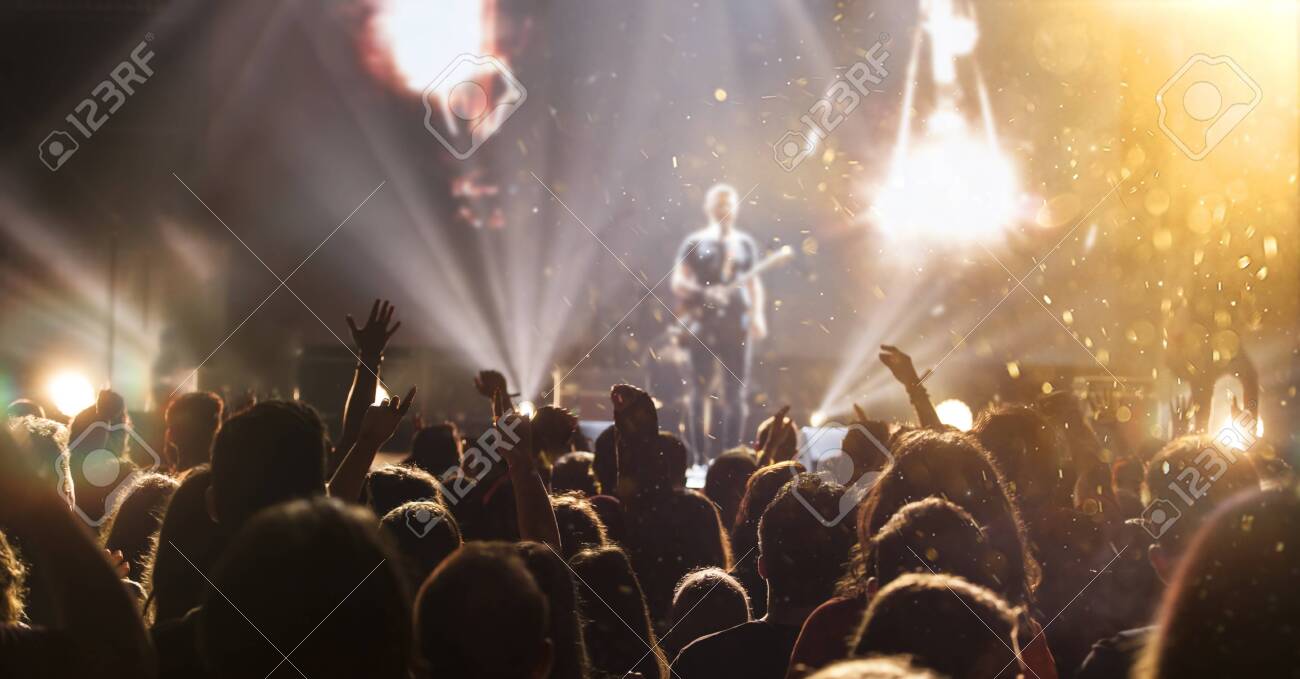 Crowd at concert - Cheering crowd in bright colorful stage lights - 121161780 Crowd at concert - Cheering crowd in bright colorful stage lights - 121161780