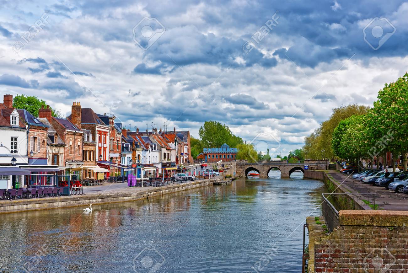 Amiens, France - May 9, 2012: Quay of Belu with traditional houses and Somme River in Amiens, Picardy, France. People on the background - 70158518 Amiens, France - May 9, 2012: Quay of Belu with traditional houses and Somme River in Amiens, Picardy, France. People on the background - 70158518