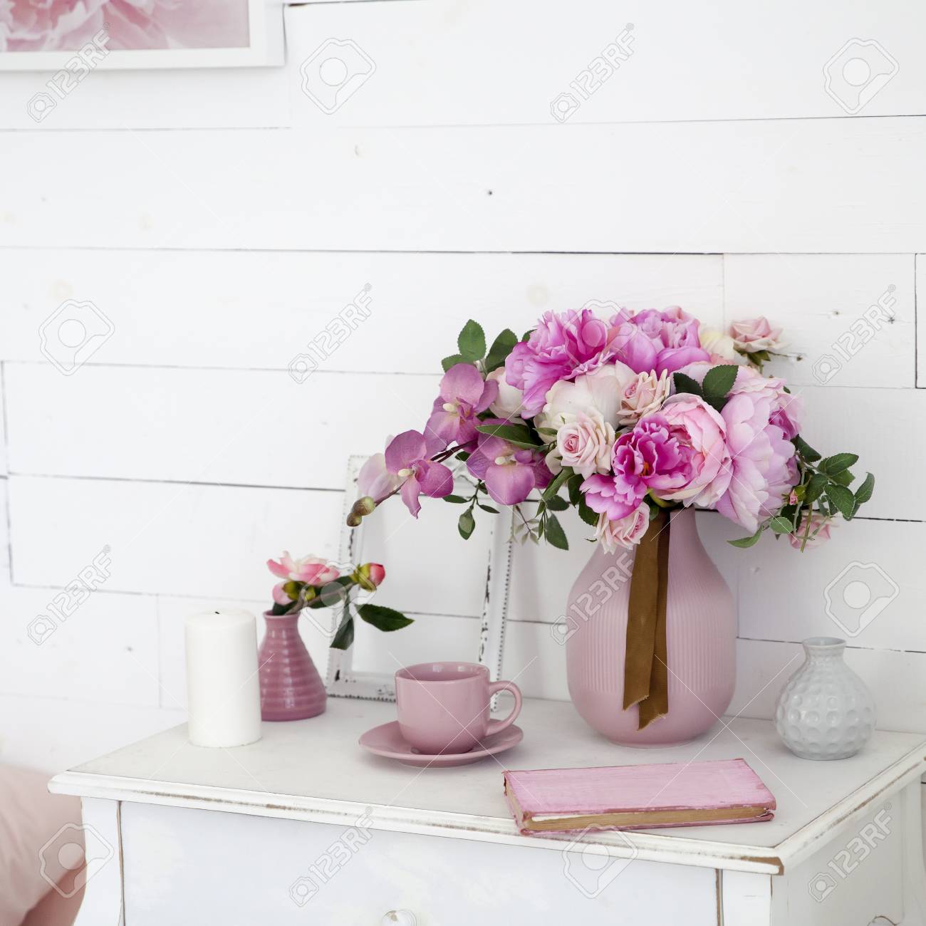 A Bouquet Of Orchids Peonies Roses In A Ceramic Vase On The