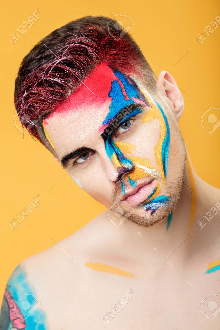 Portrait Of Young Man With Colored Face Paint On Yellow Background.  Professional Makeup Fashion. Fantasy Art Makeup Stock Photo, Picture and  Royalty Free Image. Image 77932234., image size:866x1300