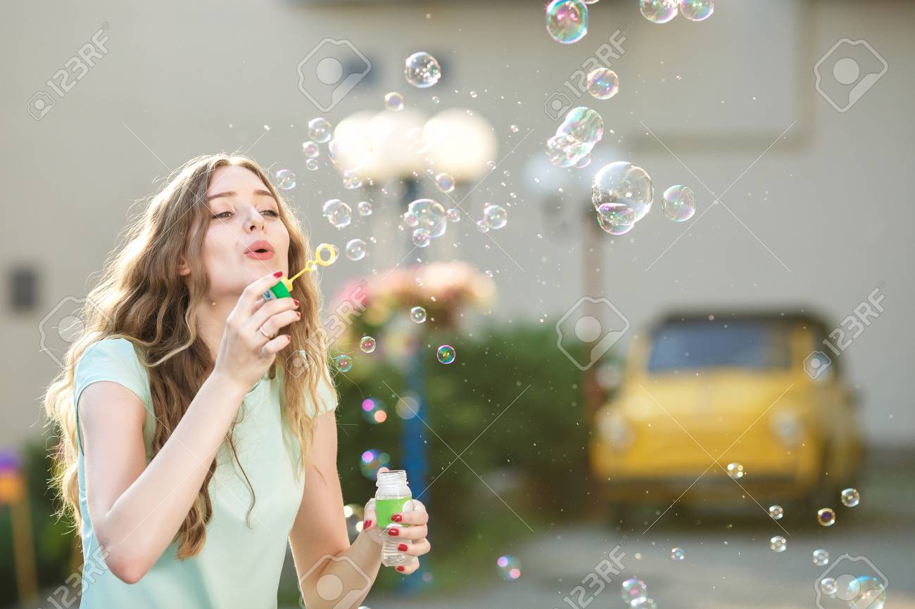 Happy Woman Blowing Soap Bubbles Stock Photo Picture And Royalty Free Image Image 85694008