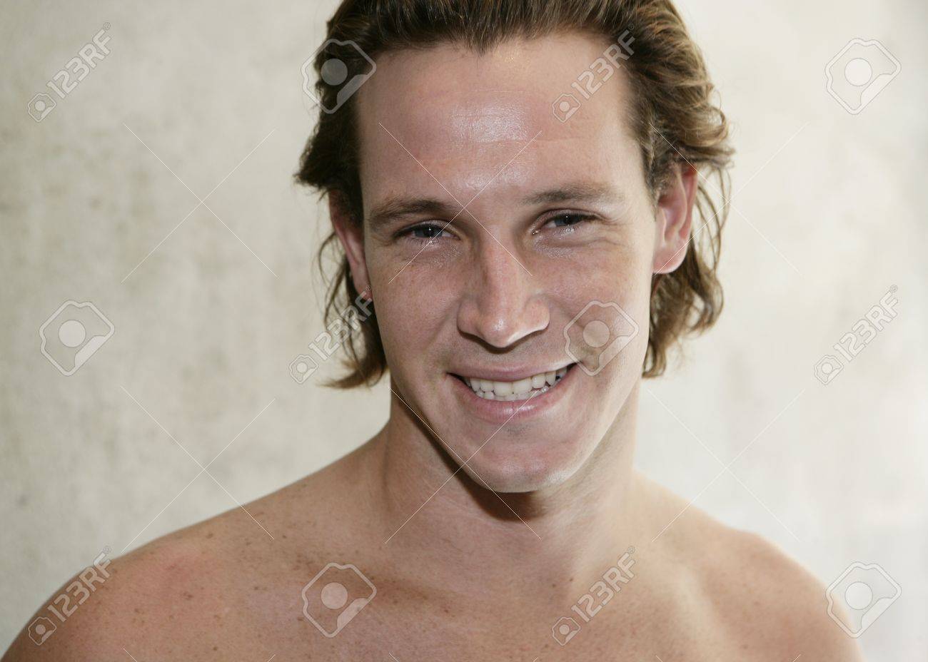 Portrait of chested young male against wall in bathroom - 7597262 Portrait of chested young male against wall in bathroom - 7597262