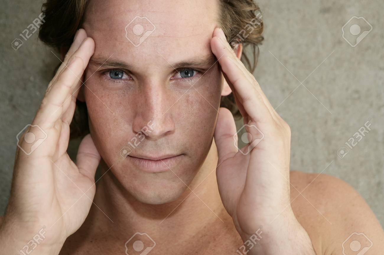 Young man with headache and holding his temples - 7597359 Young man with headache and holding his temples - 7597359