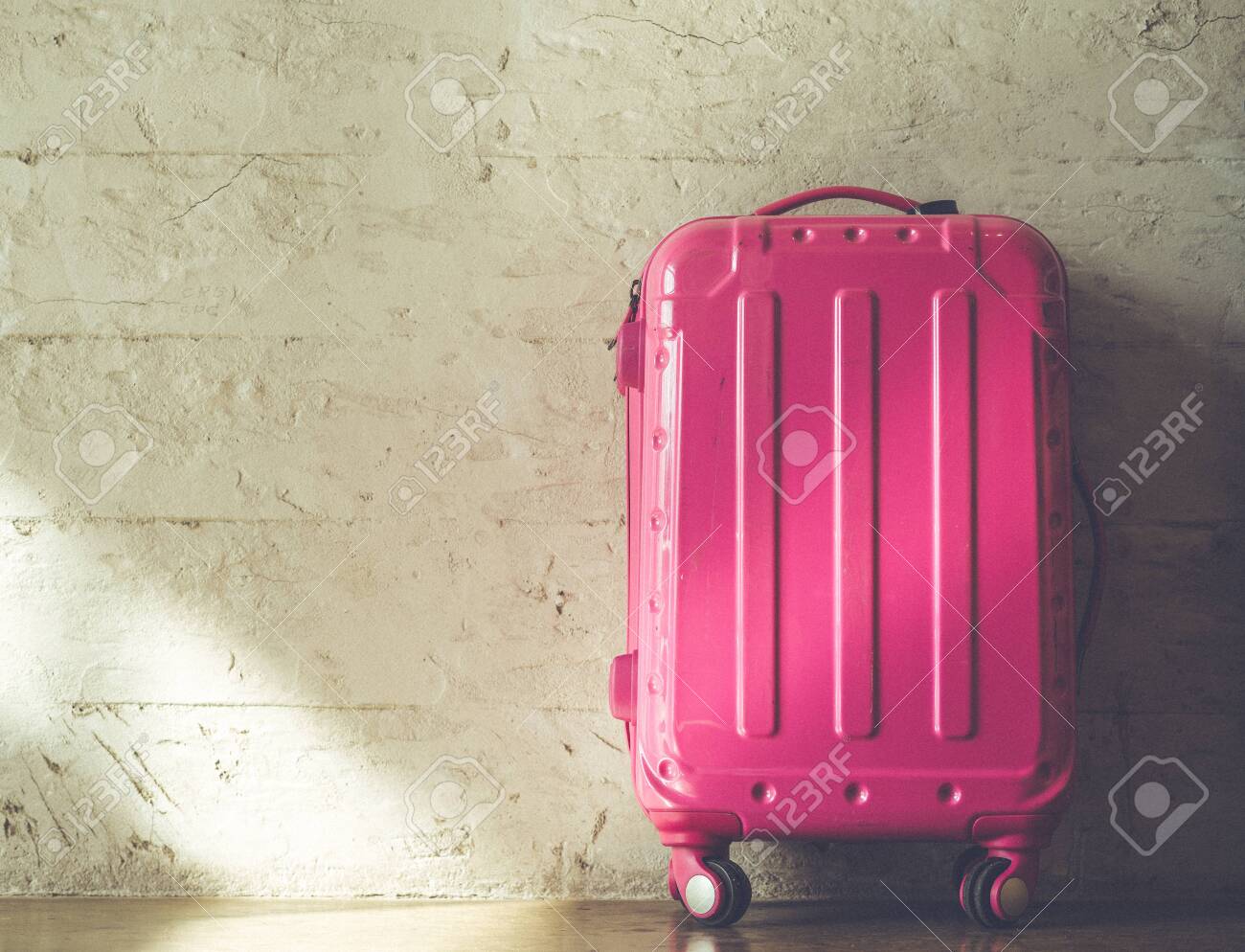 Pink suitcases on brick wall background - 120610935 Pink suitcases on brick wall background - 120610935