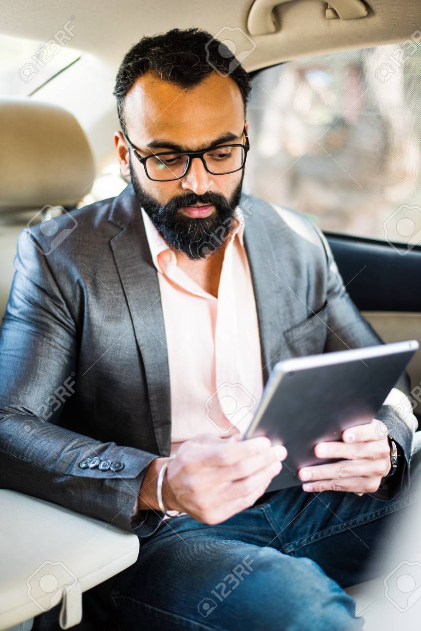 Indian/asian Young Businessman Using Tablet Computer/tab While