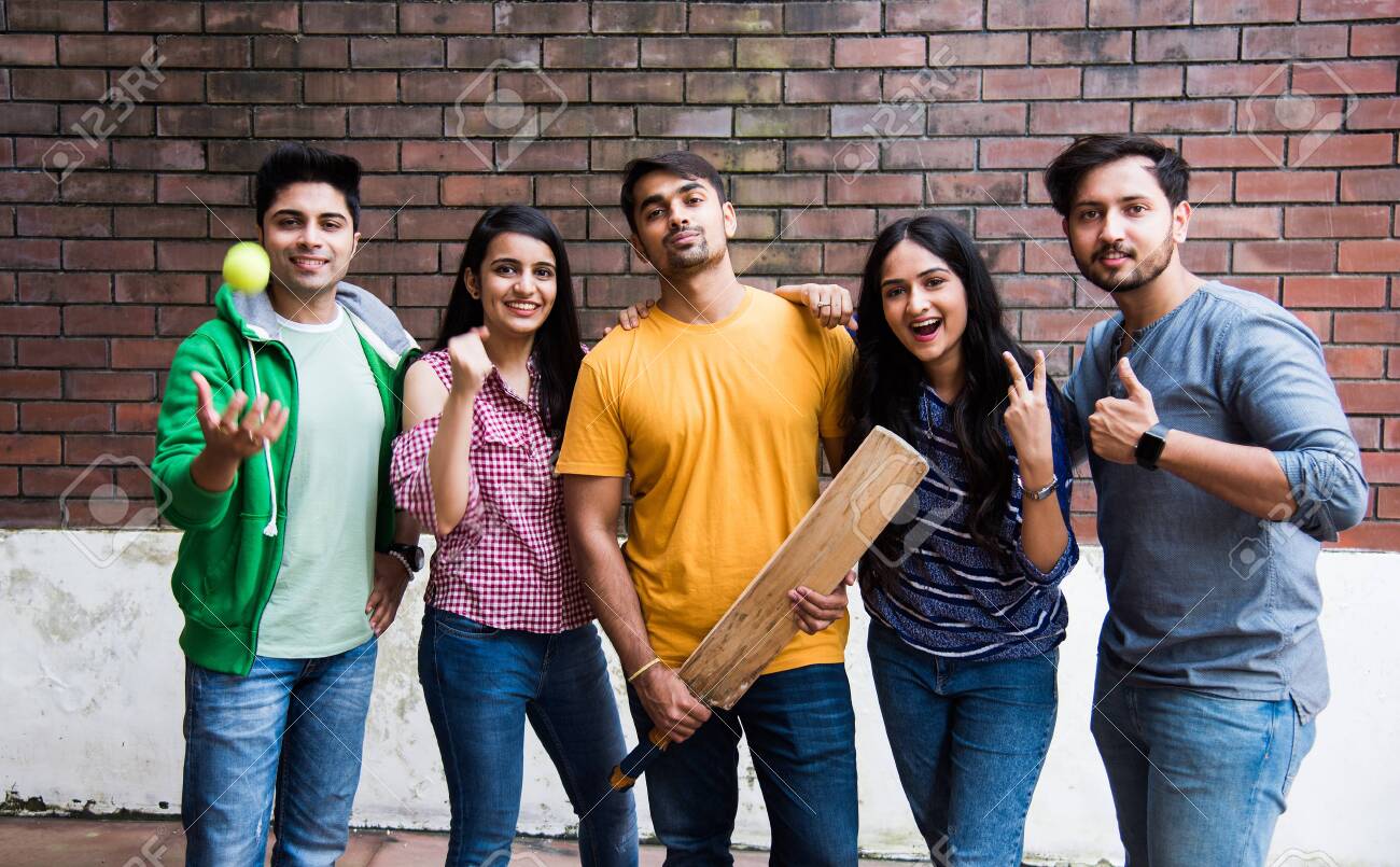 Indian Asian College Students Or Friends Playing Cricket Match As Outdoor Sport Activity Stock Photo, Picture and Royalty Free Image