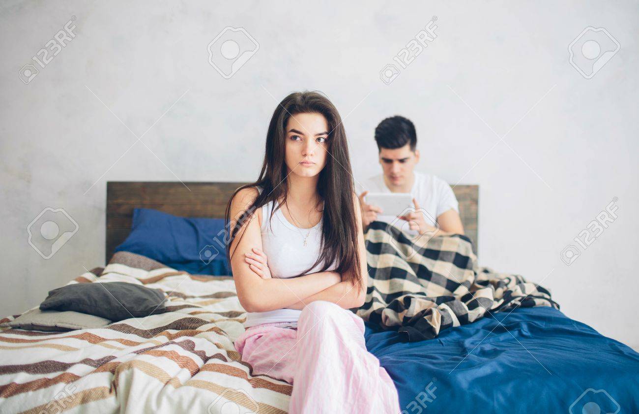 Family quarrel. The guy and the girl have strongly quarreled. The guy has a dependence on the smartphone - 74883586 Family quarrel. The guy and the girl have strongly quarreled. The guy has a dependence on the smartphone - 74883586