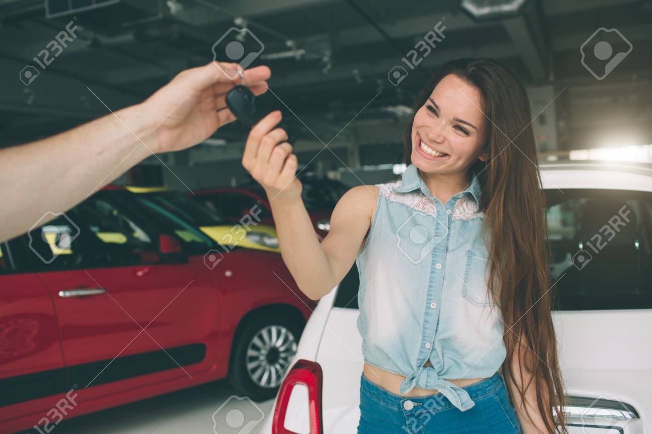Key Car Dealership >> Beautiful Young Woman Is Holding A Key In Car Dealership Auto Key Car Dealership >> Beautiful Young Woman Is Holding A Key In Car Dealership Auto
