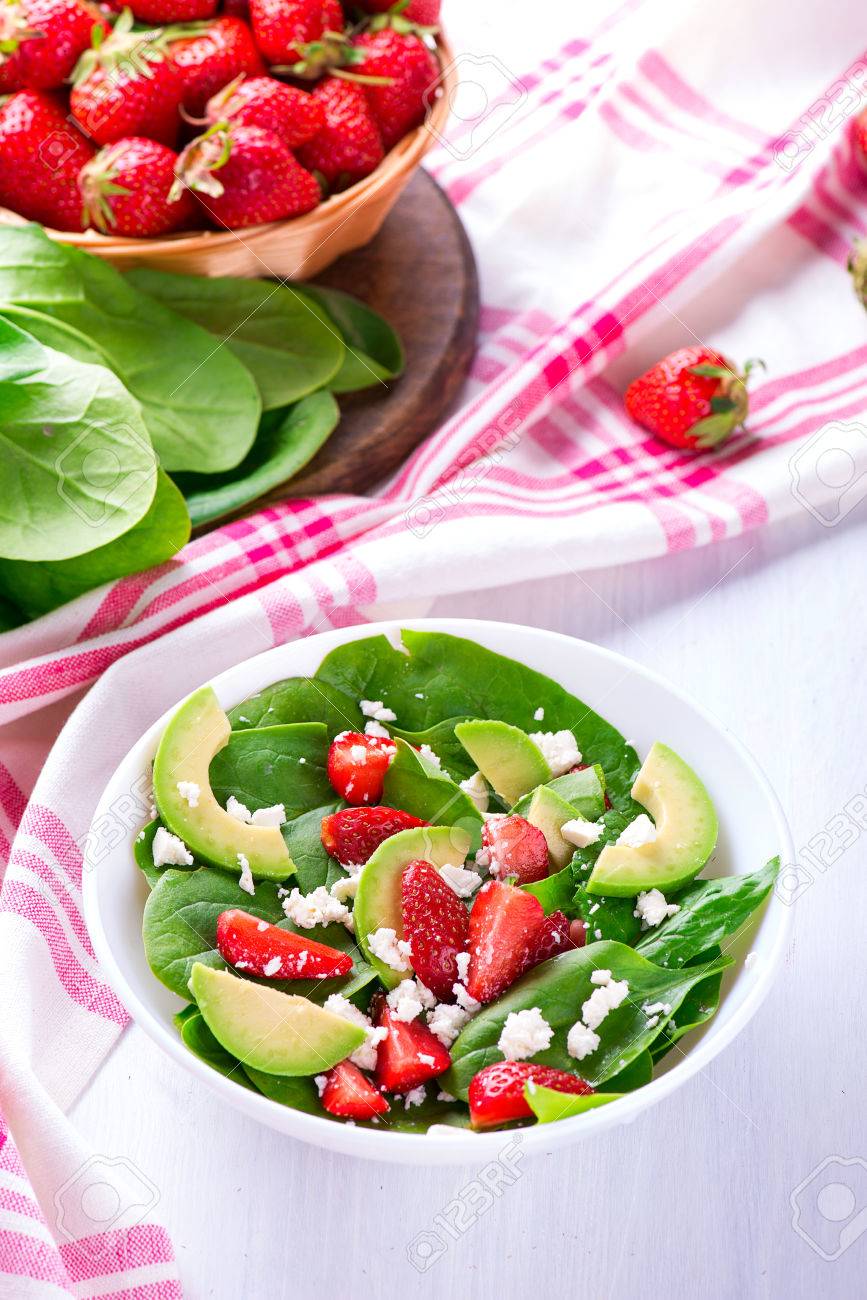 Summer salad with strawberry, avocado and spinach. White table. - 58050364 Summer salad with strawberry, avocado and spinach. White table. - 58050364