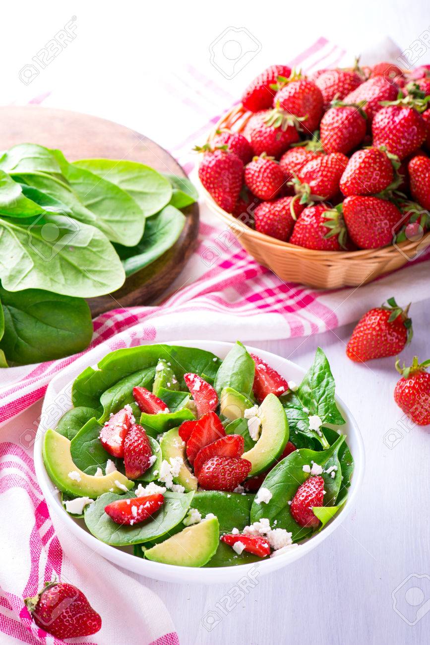Summer salad with strawberry, avocado and spinach. White table. - 58050405 Summer salad with strawberry, avocado and spinach. White table. - 58050405