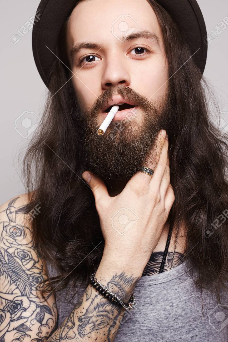 The Guy Is Smoking And Looking Handsome Bearded Man In The Hat