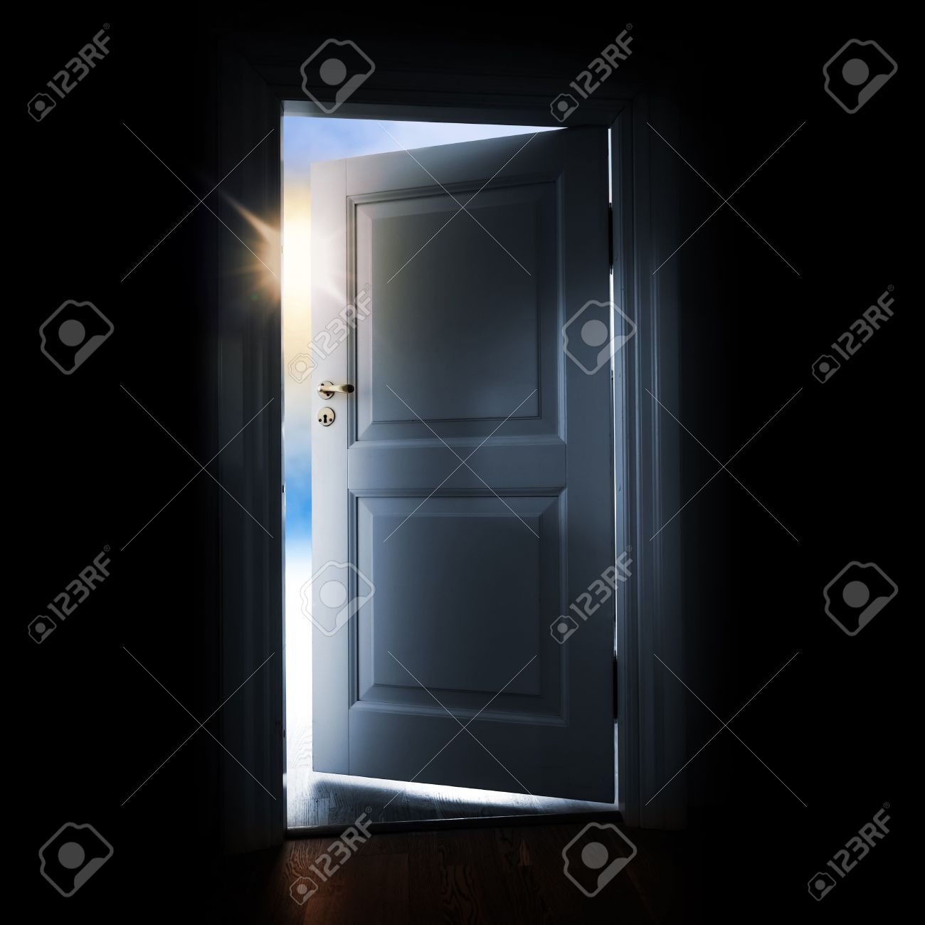 opening blue door in a dark room with shining light and sky outside stock photo opening69 light