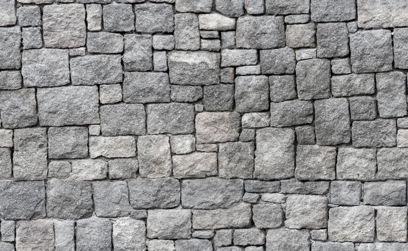 old gray stone wall seamless background photo texture stock photo