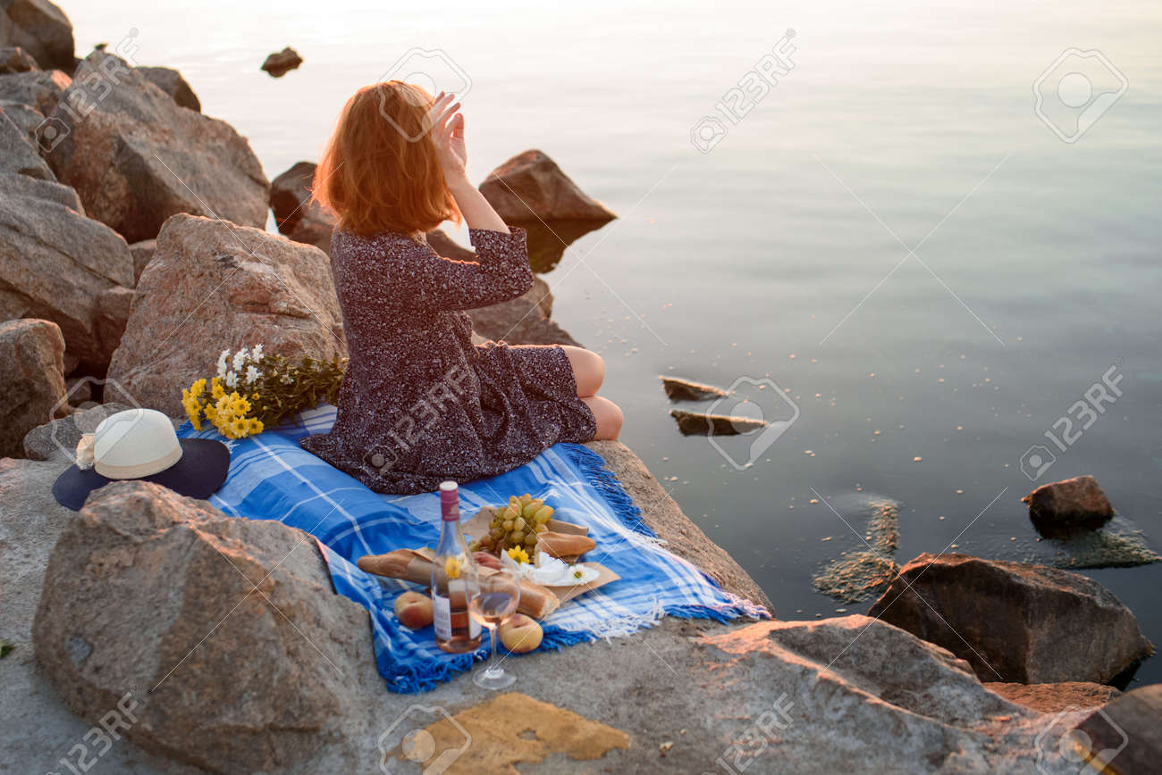 A Girl With Flowers By The Sea At Dawn At A Picnic Romantic Stock Photo Picture And Royalty Free Image Image