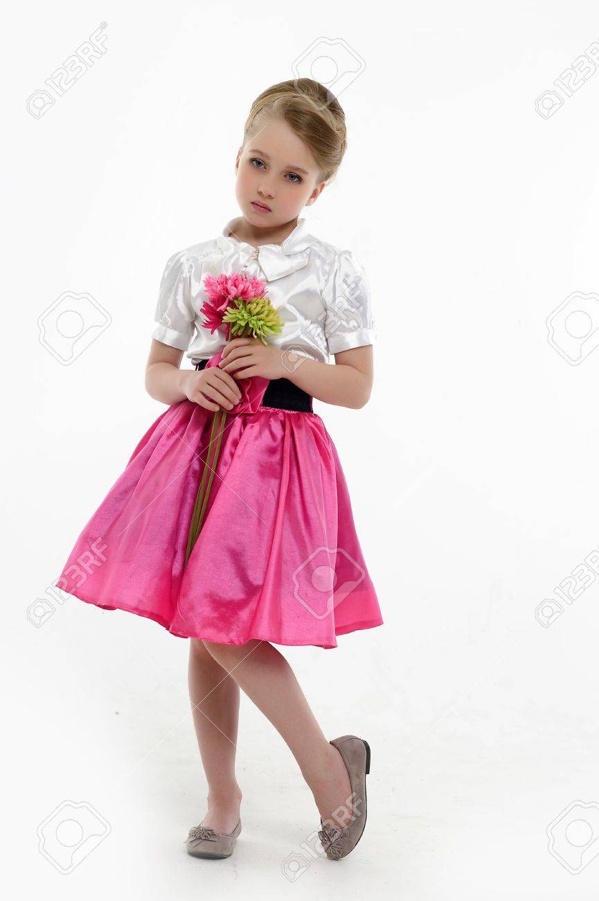Little Girl With A Retro Hairstyle And Flowers In Their Hands