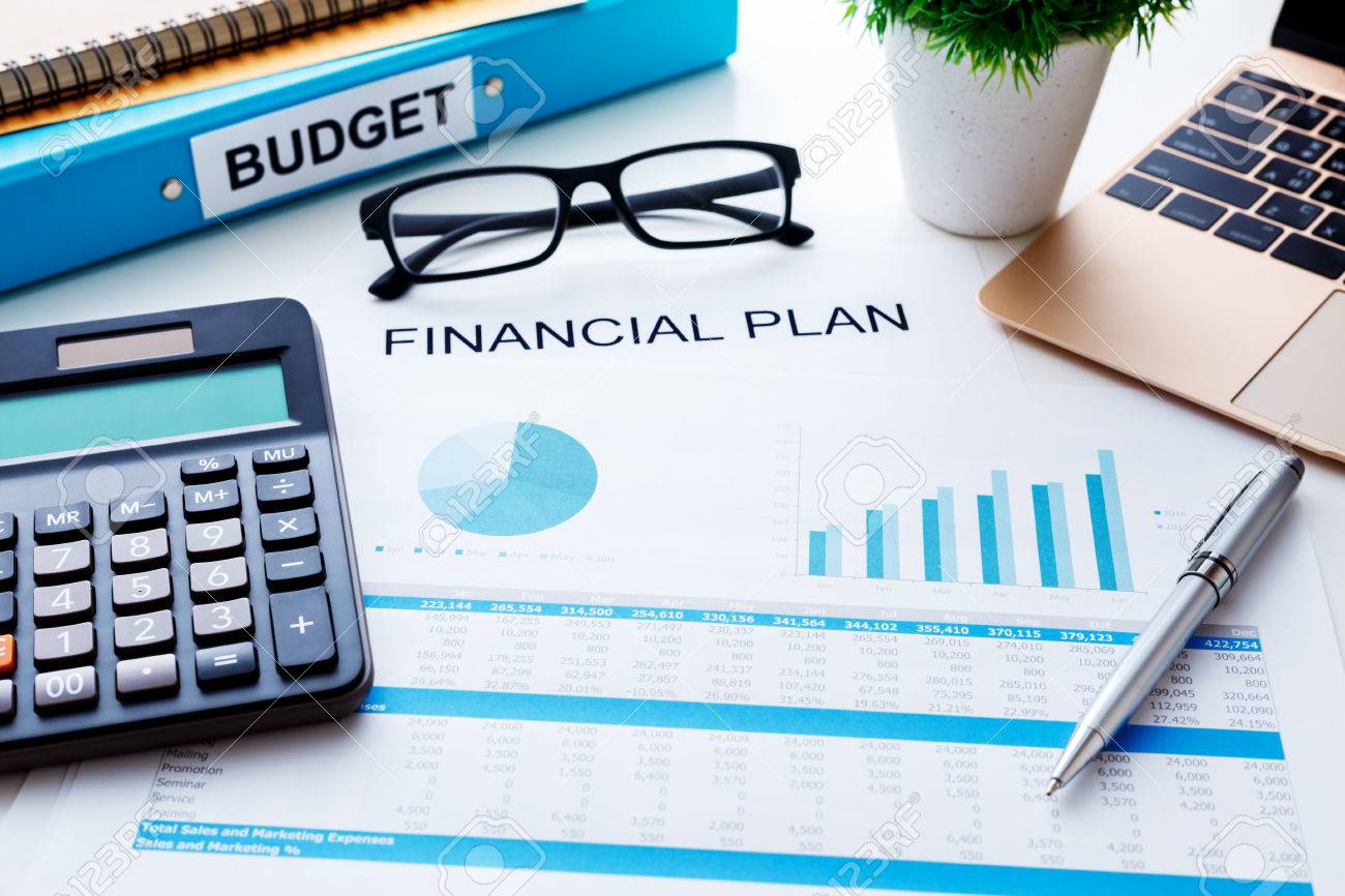 financial and budget planning concept with calculator laptop stock