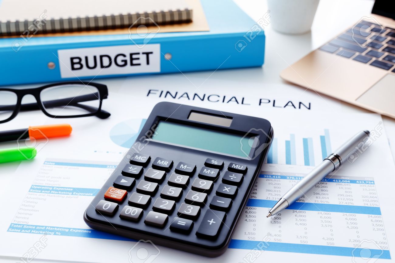 financial and budget planning concept with calculator laptop stock