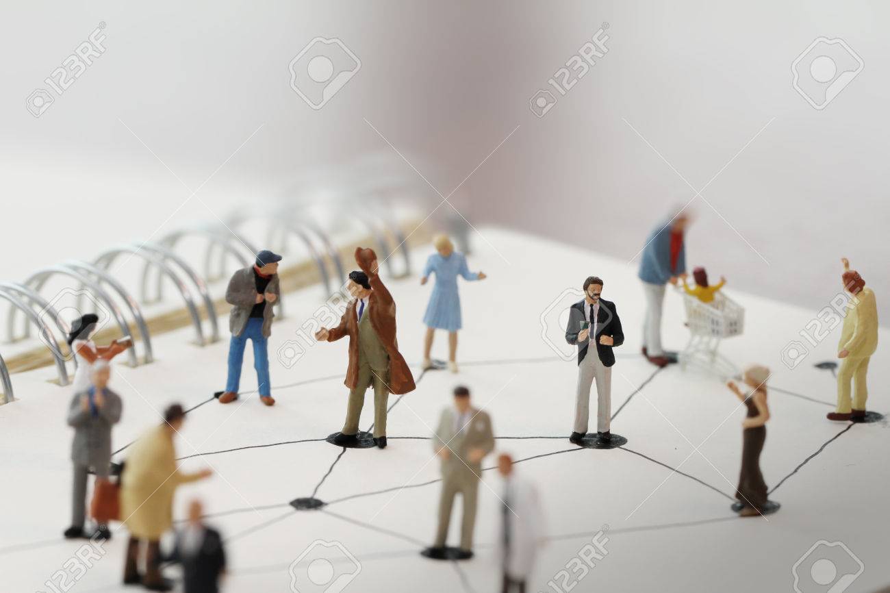 close up of miniature people with social network diagram on open notebook on wooden desk as social media conept - 38163344 close up of miniature people with social network diagram on open notebook on wooden desk as social media conept - 38163344