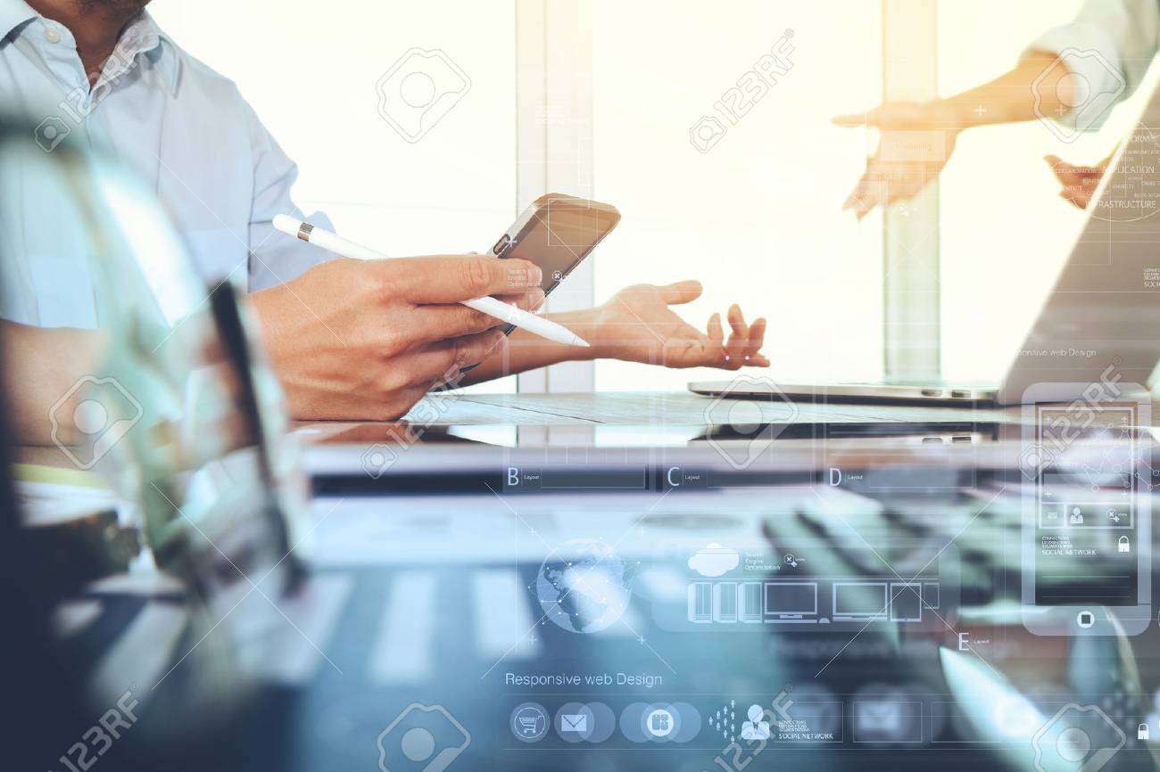 business documents on office table with smart phone and laptop computer and graph business with social network diagram and two colleagues discussing data in the background - 51496866 business documents on office table with smart phone and laptop computer and graph business with social network diagram and two colleagues discussing data in the background - 51496866