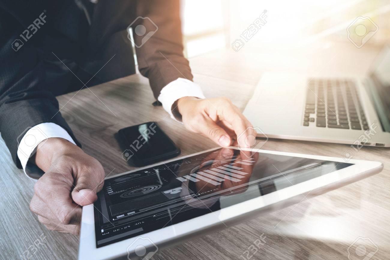businessman working with digital tablet computer and smart phone and laptop computer with digital business strategy layer effect on wooden desk as concept - 53604805 businessman working with digital tablet computer and smart phone and laptop computer with digital business strategy layer effect on wooden desk as concept - 53604805