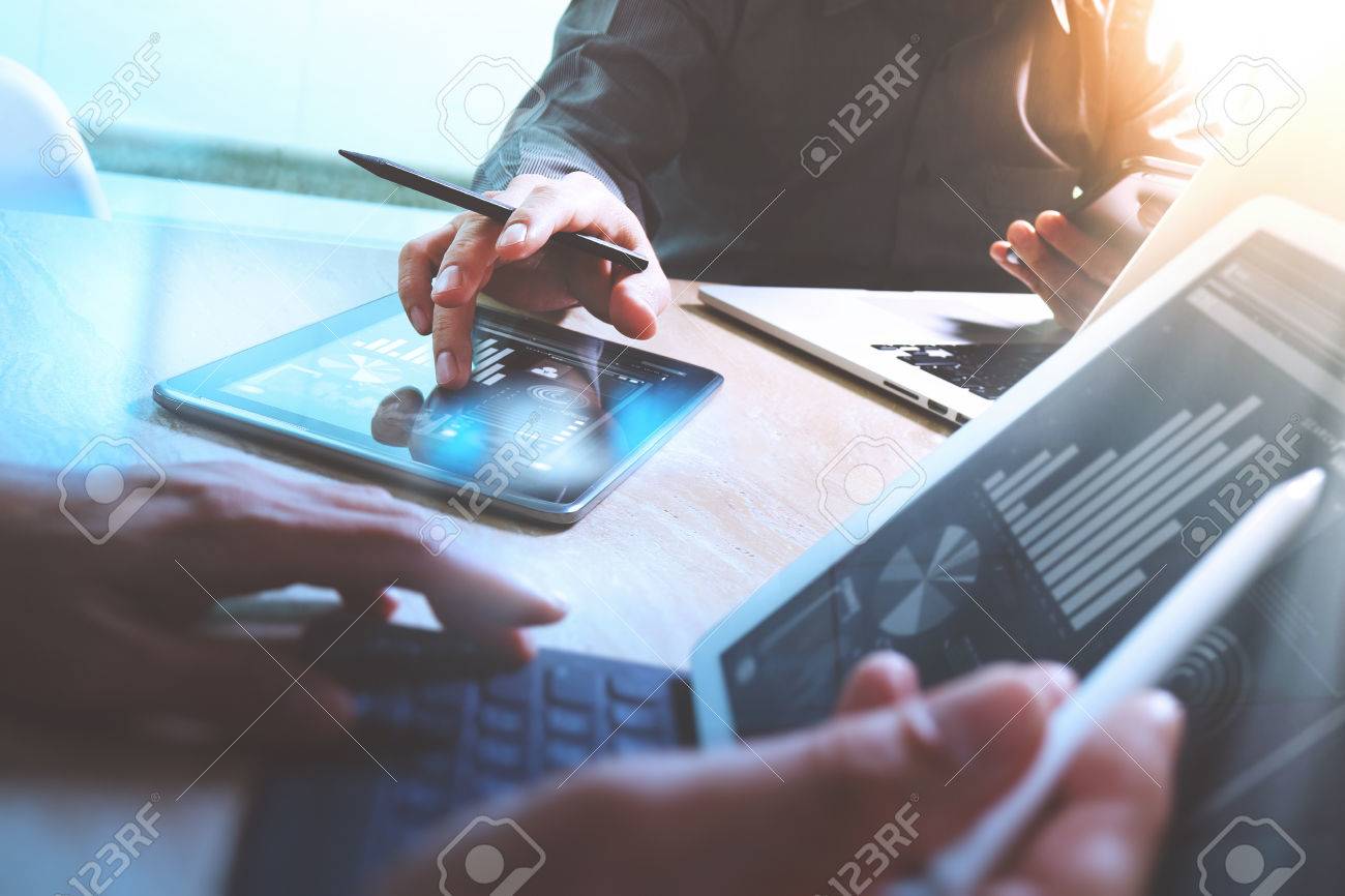 Business team meeting present. Photo professional investor working with new startup project. Finance managers meeting.Digital tablet laptop computer design smart phone using, keyboard docking screen foreground - 64118427 Business team meeting present. Photo professional investor working with new startup project. Finance managers meeting.Digital tablet laptop computer design smart phone using, keyboard docking screen foreground - 64118427