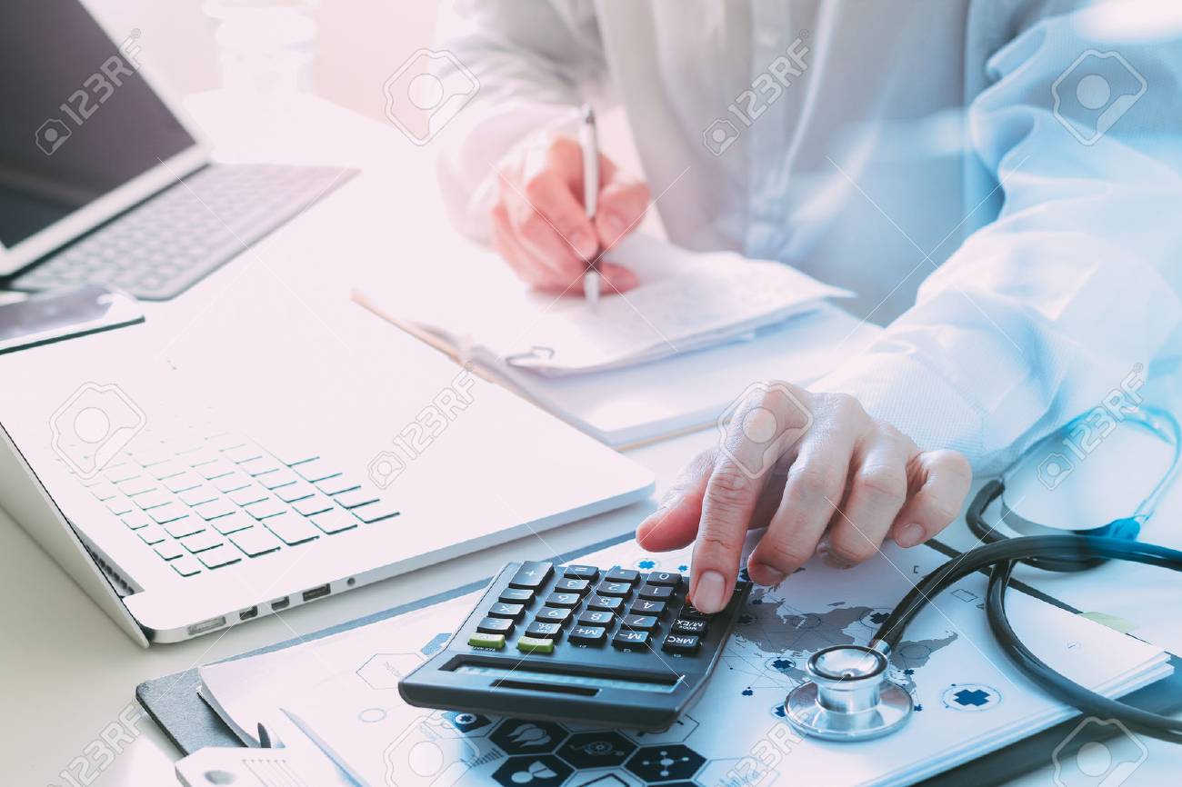 Healthcare costs and fees concept.Hand of smart doctor used a calculator for medical costs in modern hospital - 80116199 Healthcare costs and fees concept.Hand of smart doctor used a calculator for medical costs in modern hospital - 80116199