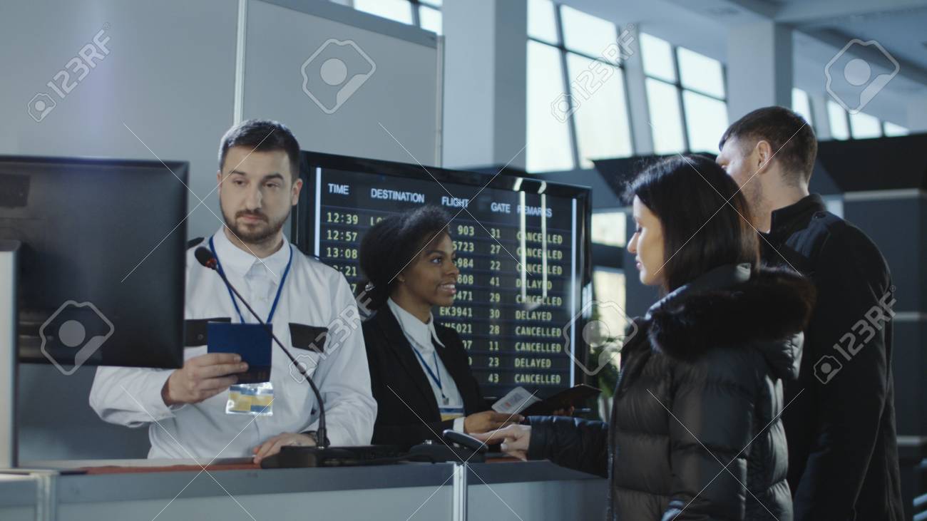 Diverse employees of airport checking passports and biometric data working with passengers. - 98212001 Diverse employees of airport checking passports and biometric data working with passengers. - 98212001