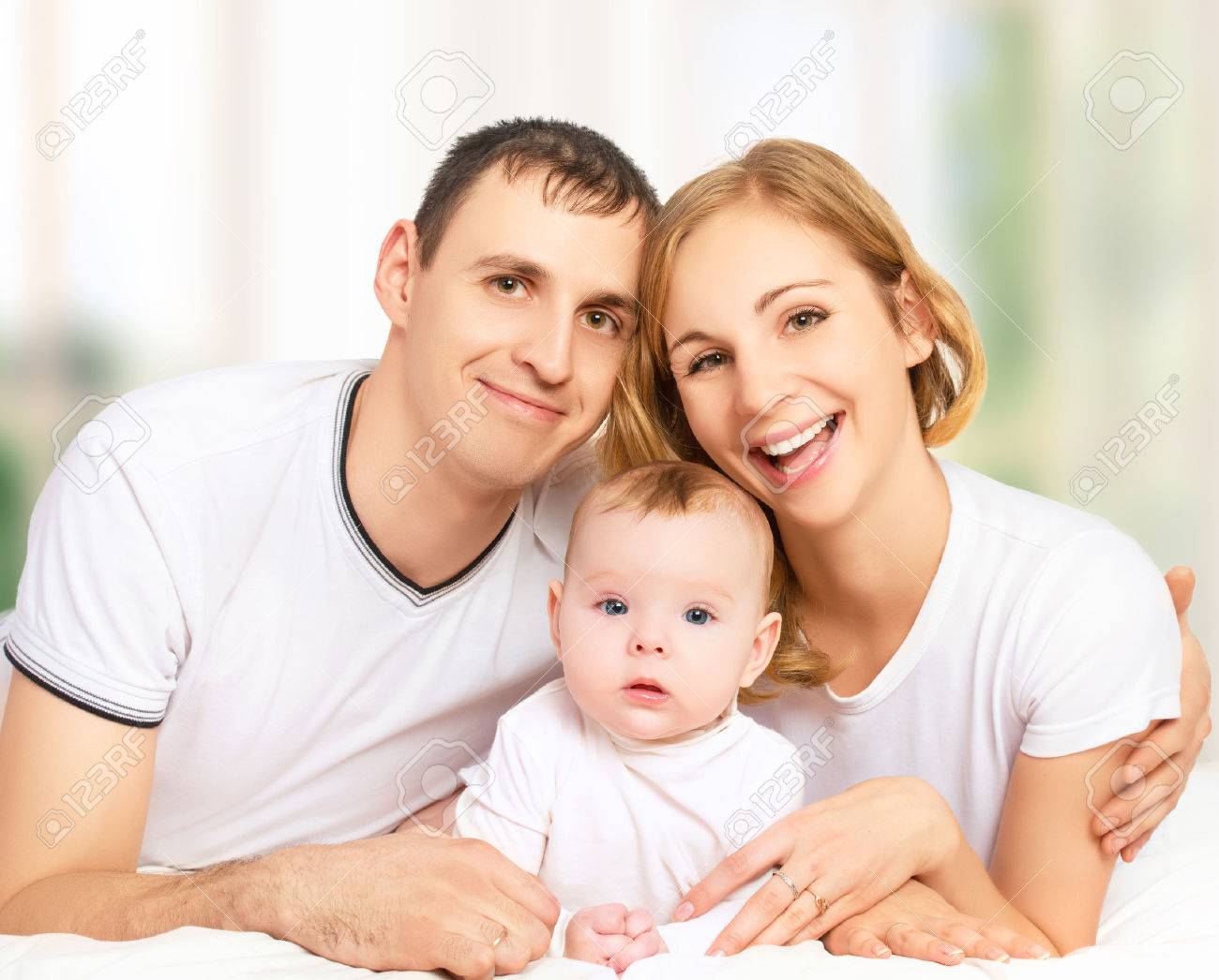 Happy Family Of Father, Mother And Small Baby Girl Daughter In ...