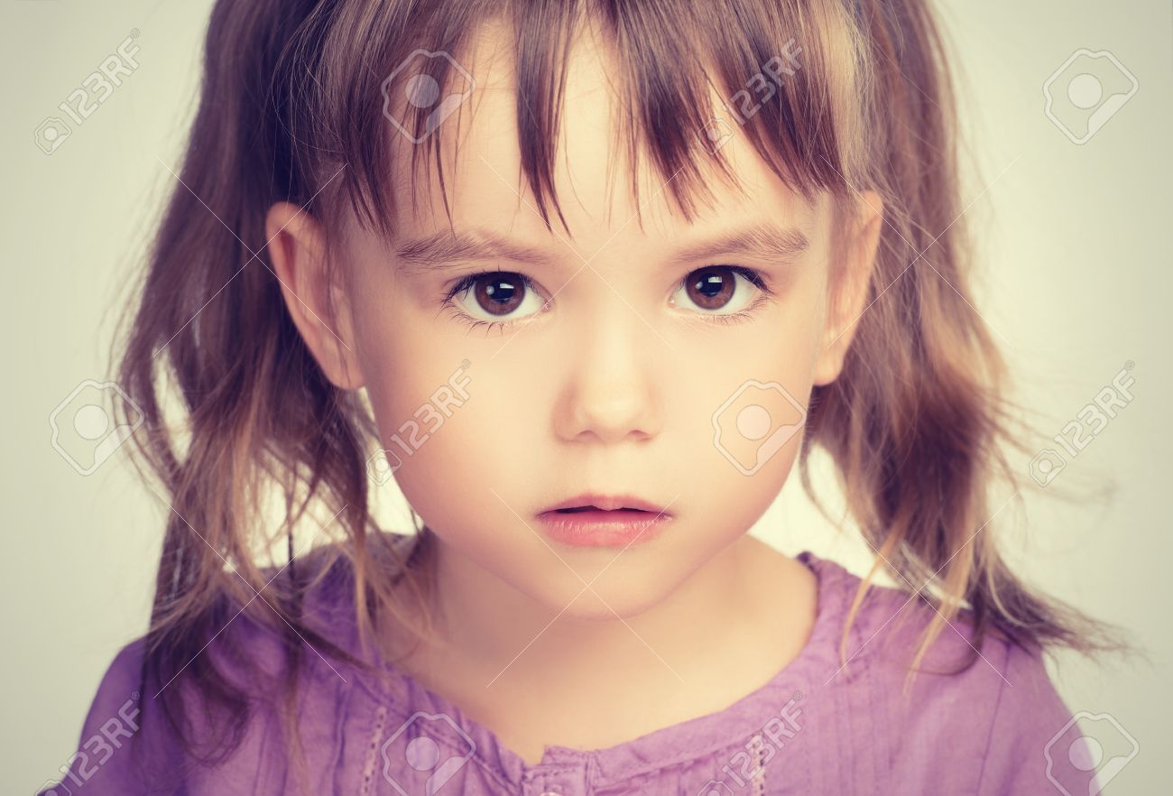 Face Of A Little Beautiful Girl With Sad Eyes Stock Photo, Picture ...