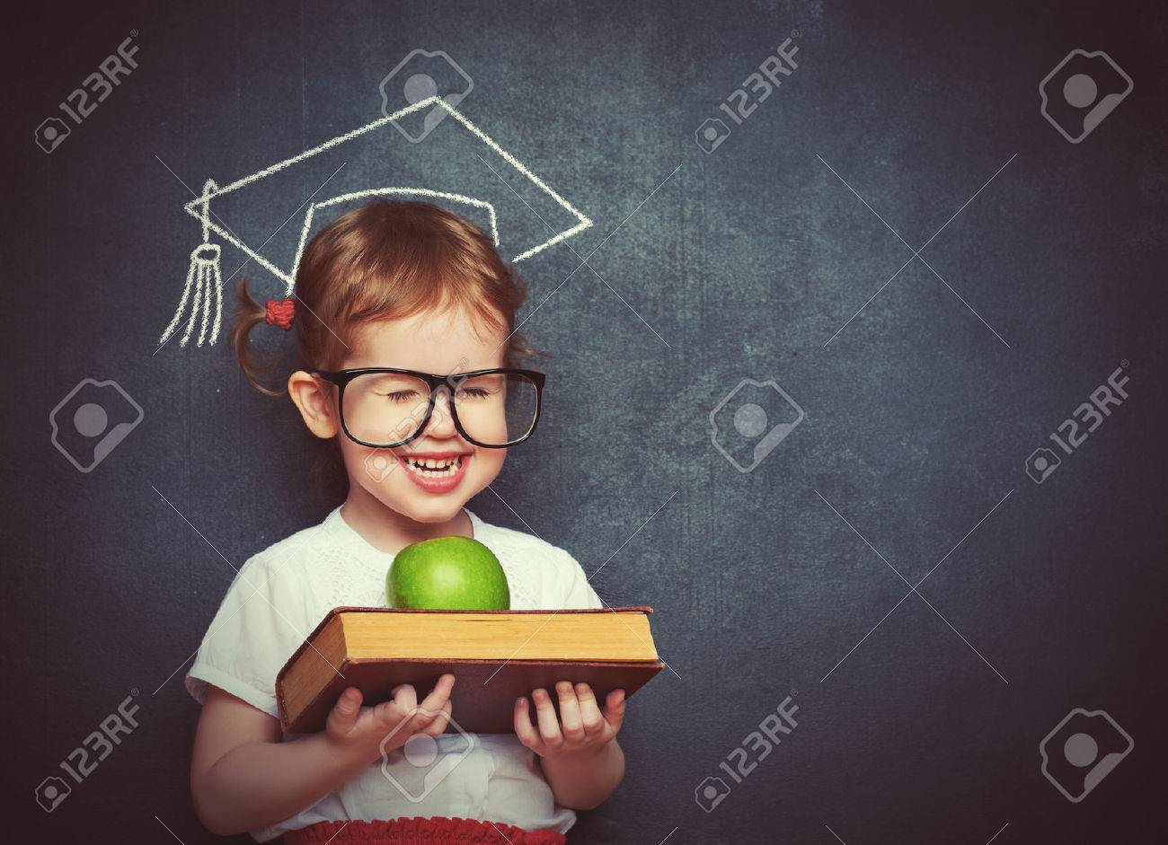 pretty little girl schoolgirl with books and apple in a school board - 39209178 pretty little girl schoolgirl with books and apple in a school board - 39209178