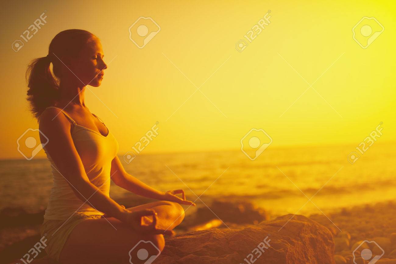 yoga in the beach. woman meditating in lotus pose on the beach at sunset - 41163869 yoga in the beach. woman meditating in lotus pose on the beach at sunset - 41163869