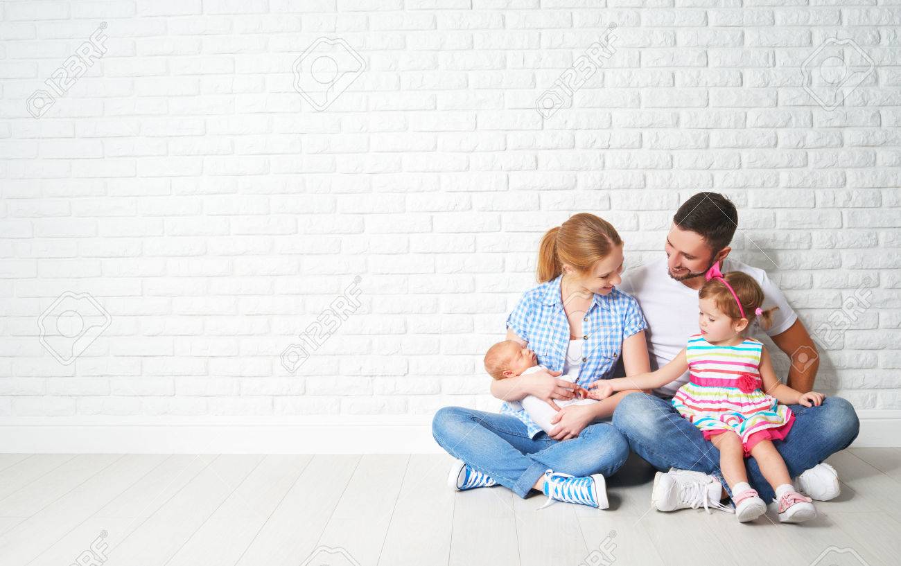 happy family father mother and children sitting on the floor in an empty brick wall - 51033624 happy family father mother and children sitting on the floor in an empty brick wall - 51033624