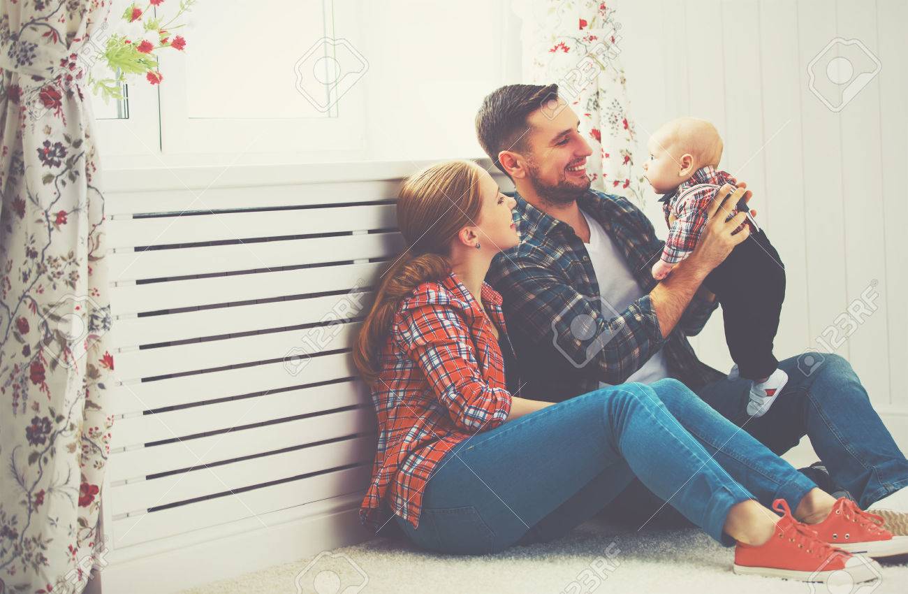 happy family mother and father playing with a baby at home - 52156050 happy family mother and father playing with a baby at home - 52156050