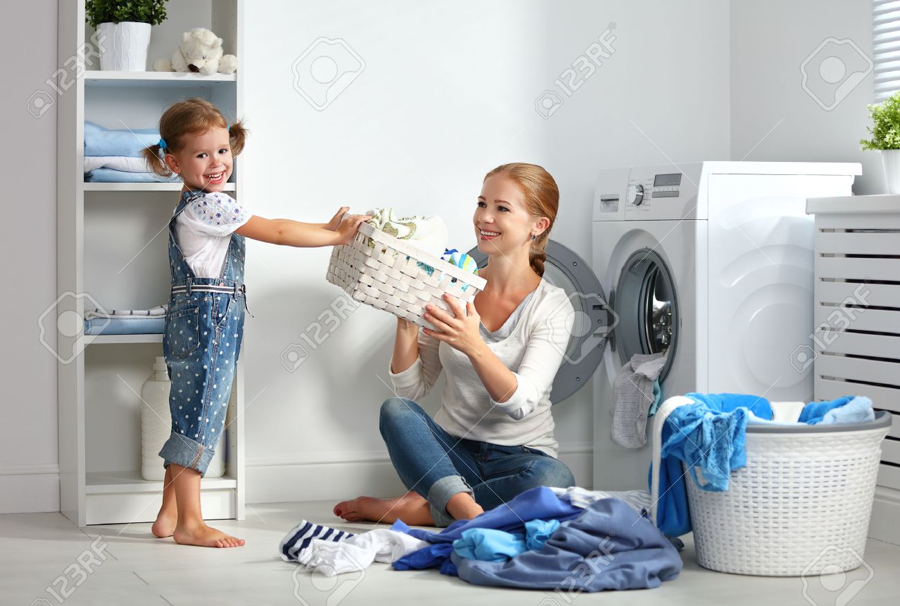 family mother and child girl little helper in laundry room near washing machine and dirty clothes - 61805861 family mother and child girl little helper in laundry room near washing machine and dirty clothes - 61805861